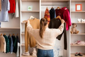 Woman holding sweaters in front of closet, Woman in front of closet, Style Degree, Singapore, SG, StyleMag.